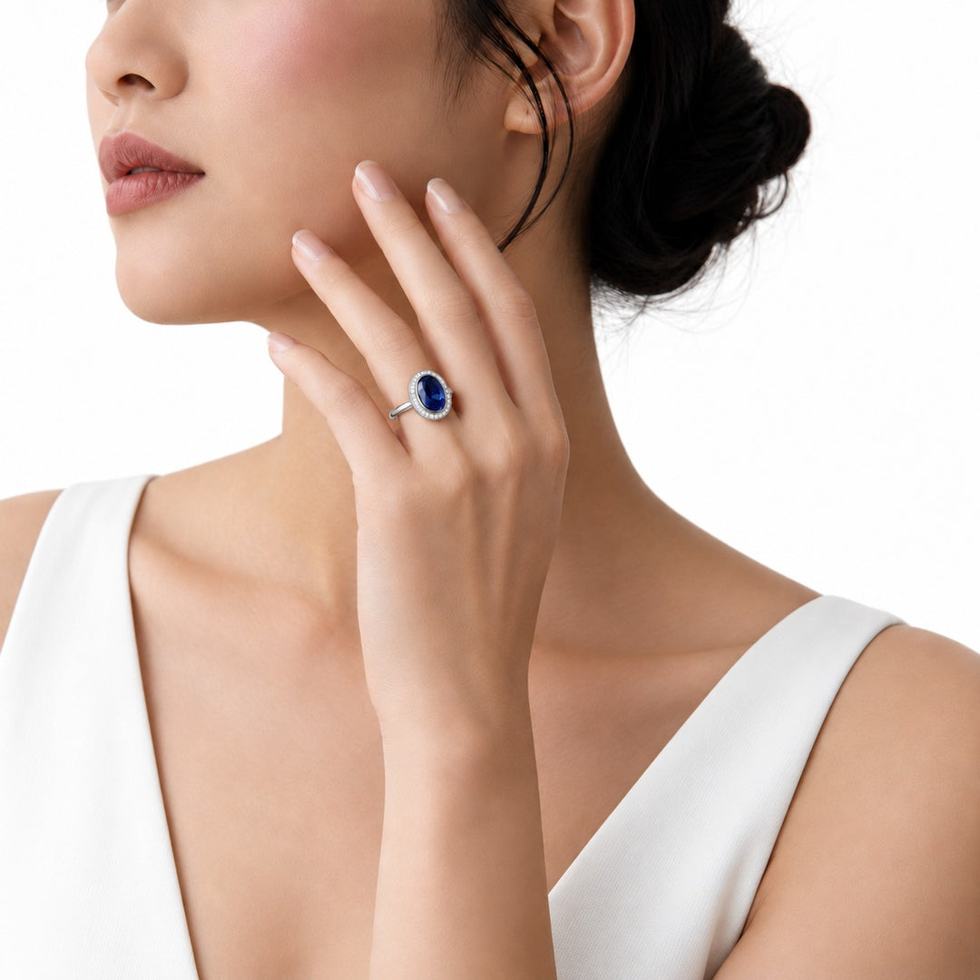 The Celine vintage lab sapphire halo ring in platinum, worn on hand