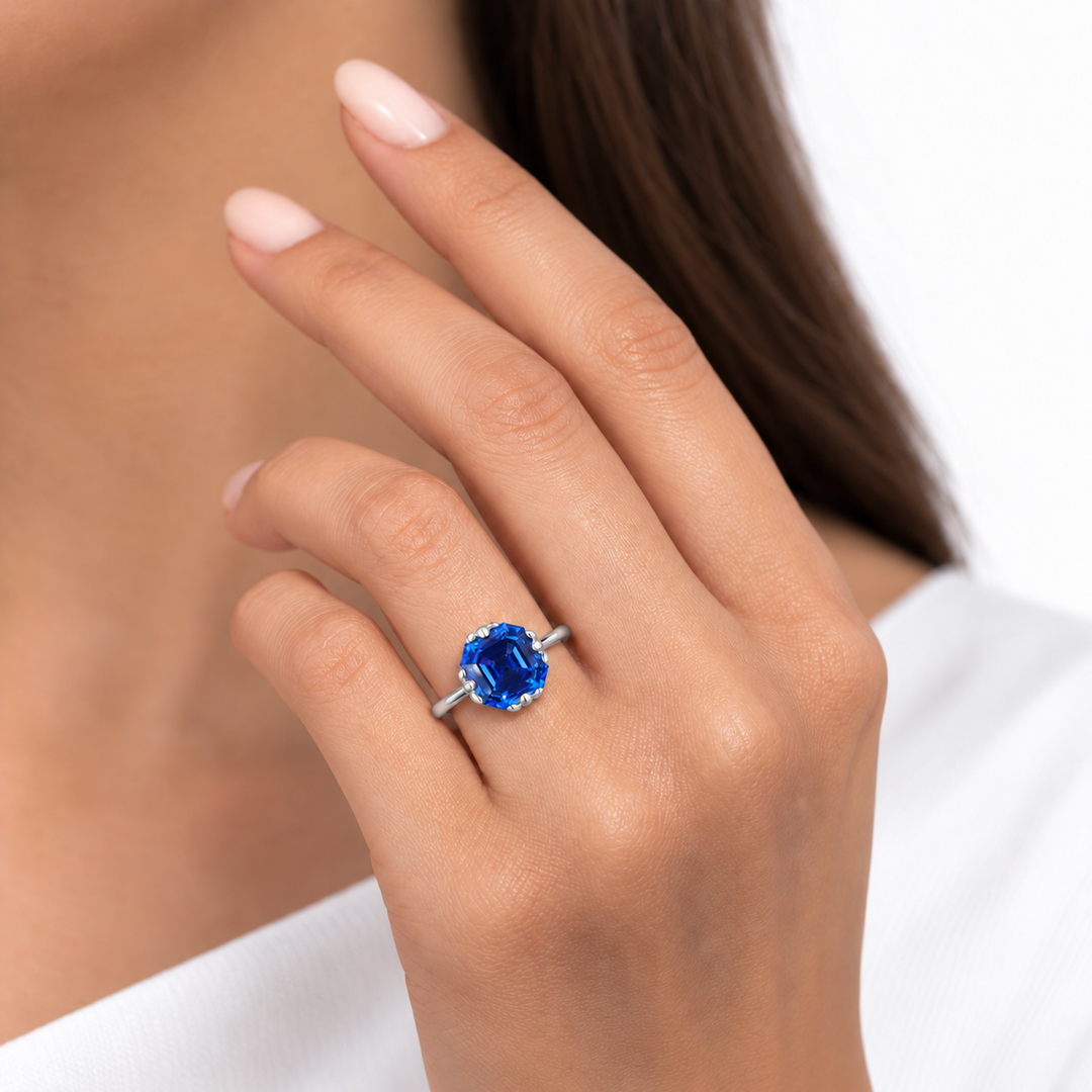 The Verena Asscher blue sapphire ring with leaf prongs in platinum, worn on hand