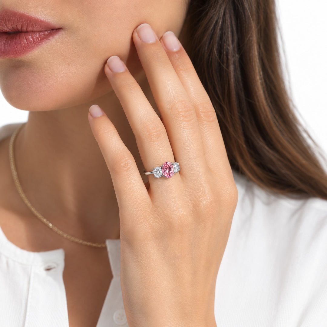 The Étoile oval pink lab sapphire three-stone ring in 14K white gold, worn on hand