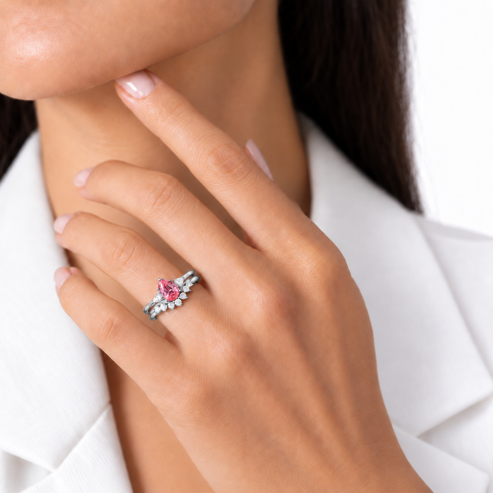 The Aubrey Set pink pear sapphire three-stone ring and diamond band in platinum, worn on hand, ring only