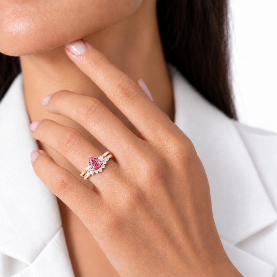 The Aubrey Set pink pear sapphire three-stone ring and diamond band in 14K rose gold, worn on hand, ring only