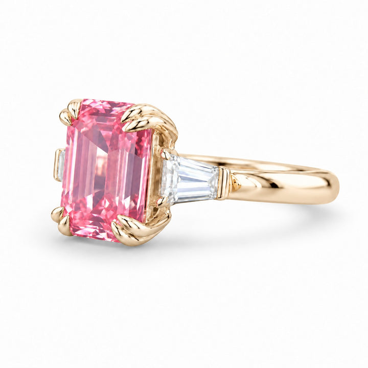 The Lumen pink lab sapphire baguette ring in 14K yellow gold, angled view