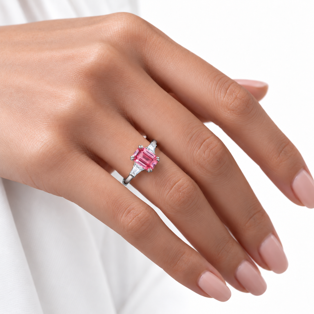 The Lumen pink lab sapphire baguette ring in platinum, worn on hand