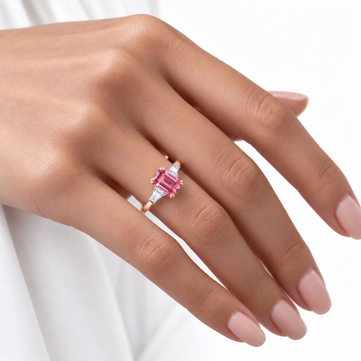The Lumen pink lab sapphire baguette ring in 14K rose gold, worn on hand