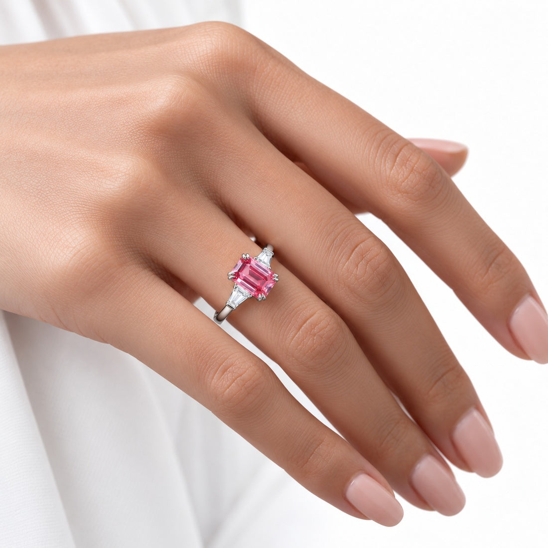 The Lumen pink lab sapphire baguette ring in 14K white gold, worn on hand