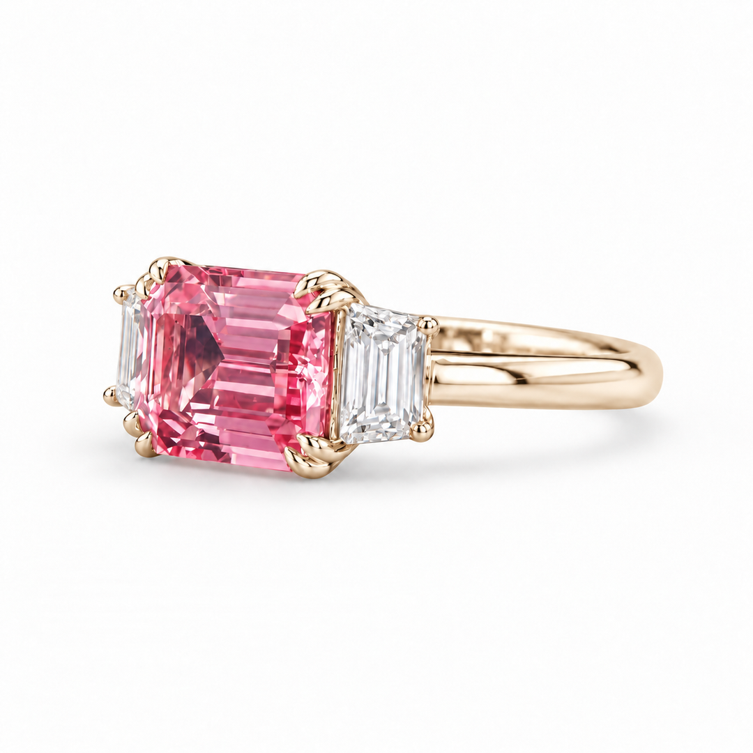 The Maribel pink lab sapphire three-stone ring in 14K yellow gold, angled view