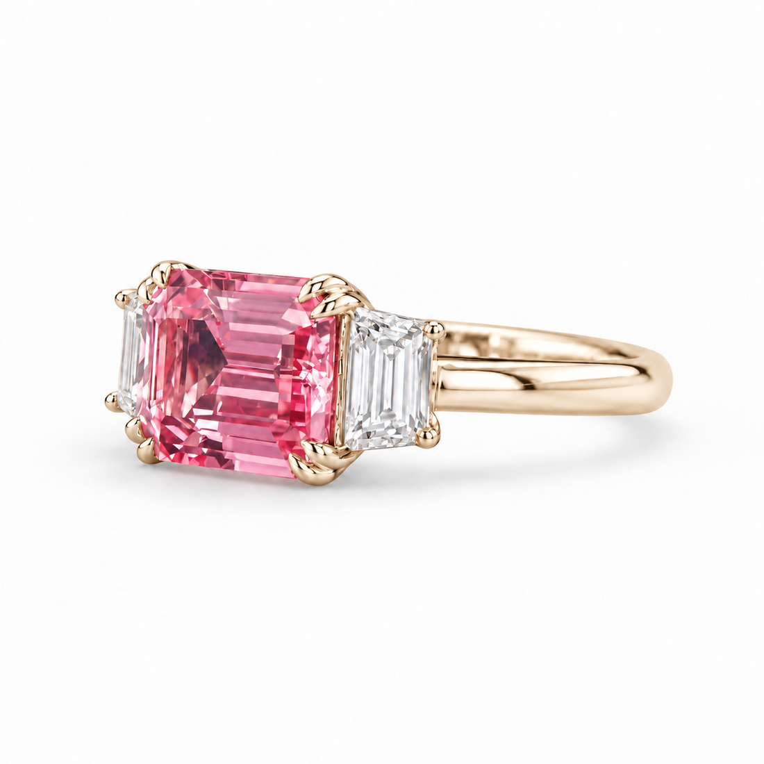 The Maribel pink lab sapphire three-stone ring in 14K yellow gold, angled view