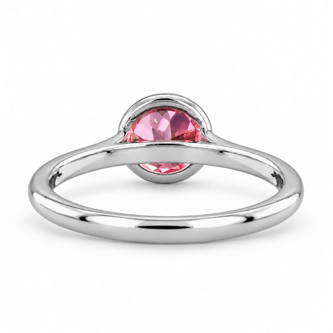 The Lune pink lab sapphire bezel solitaire ring in platinum, back view