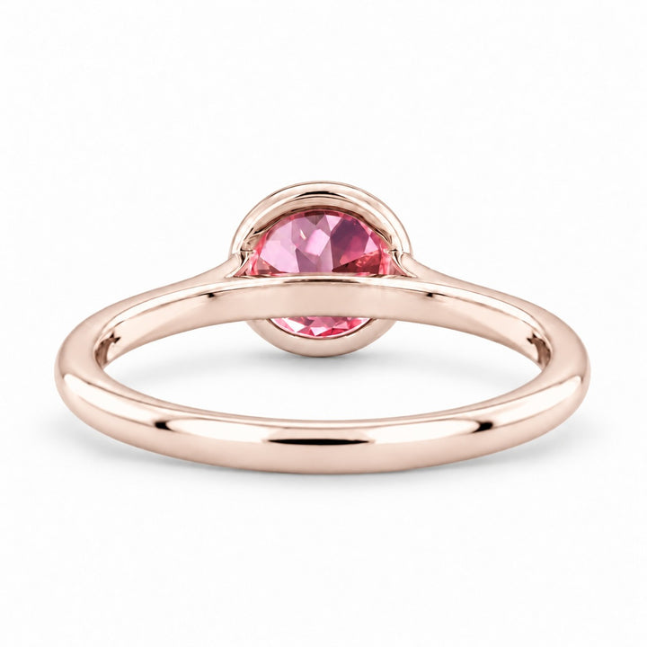 The Lune pink lab sapphire bezel solitaire ring in 14K rose gold, back view