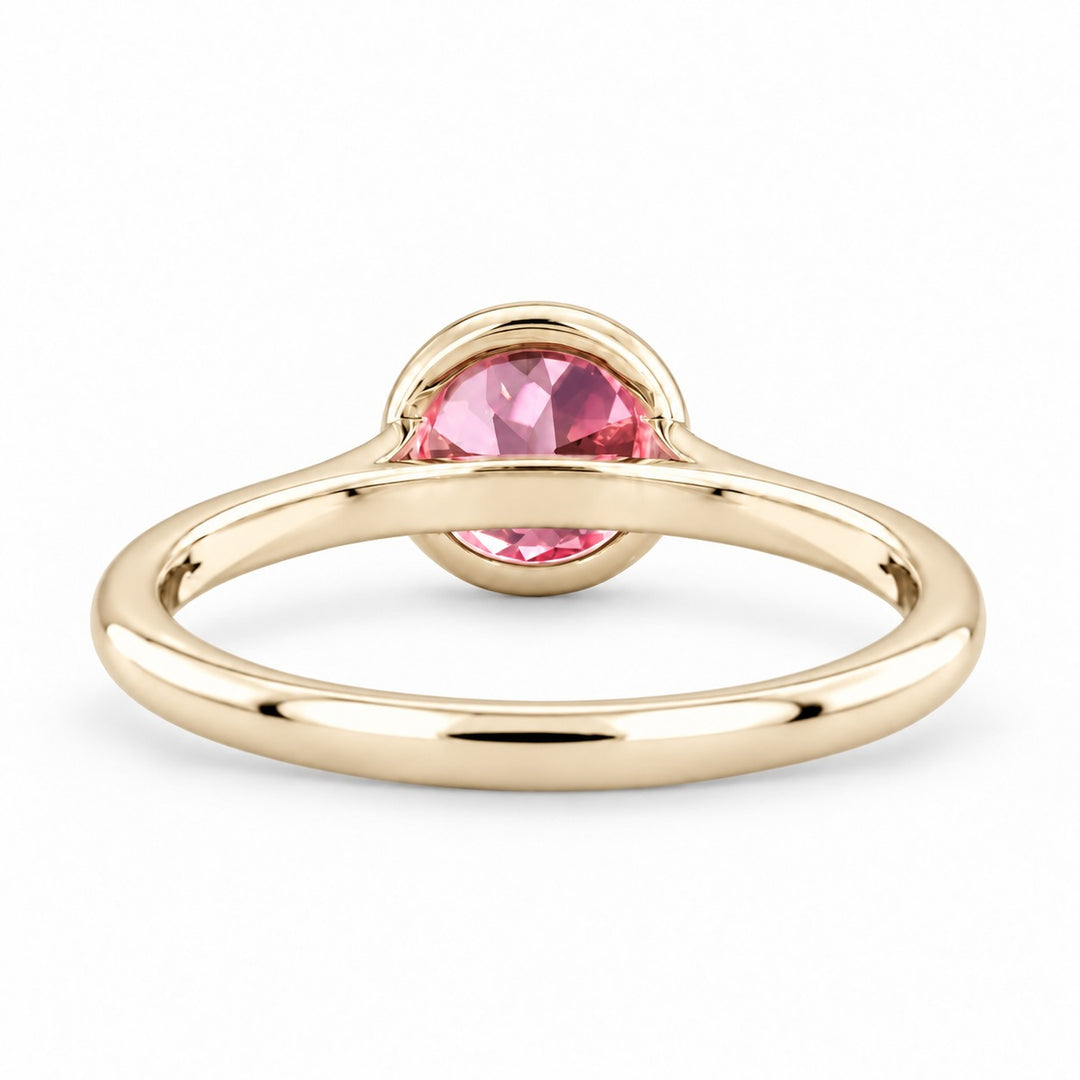 The Lune pink lab sapphire bezel solitaire ring in 14K yellow gold, back view