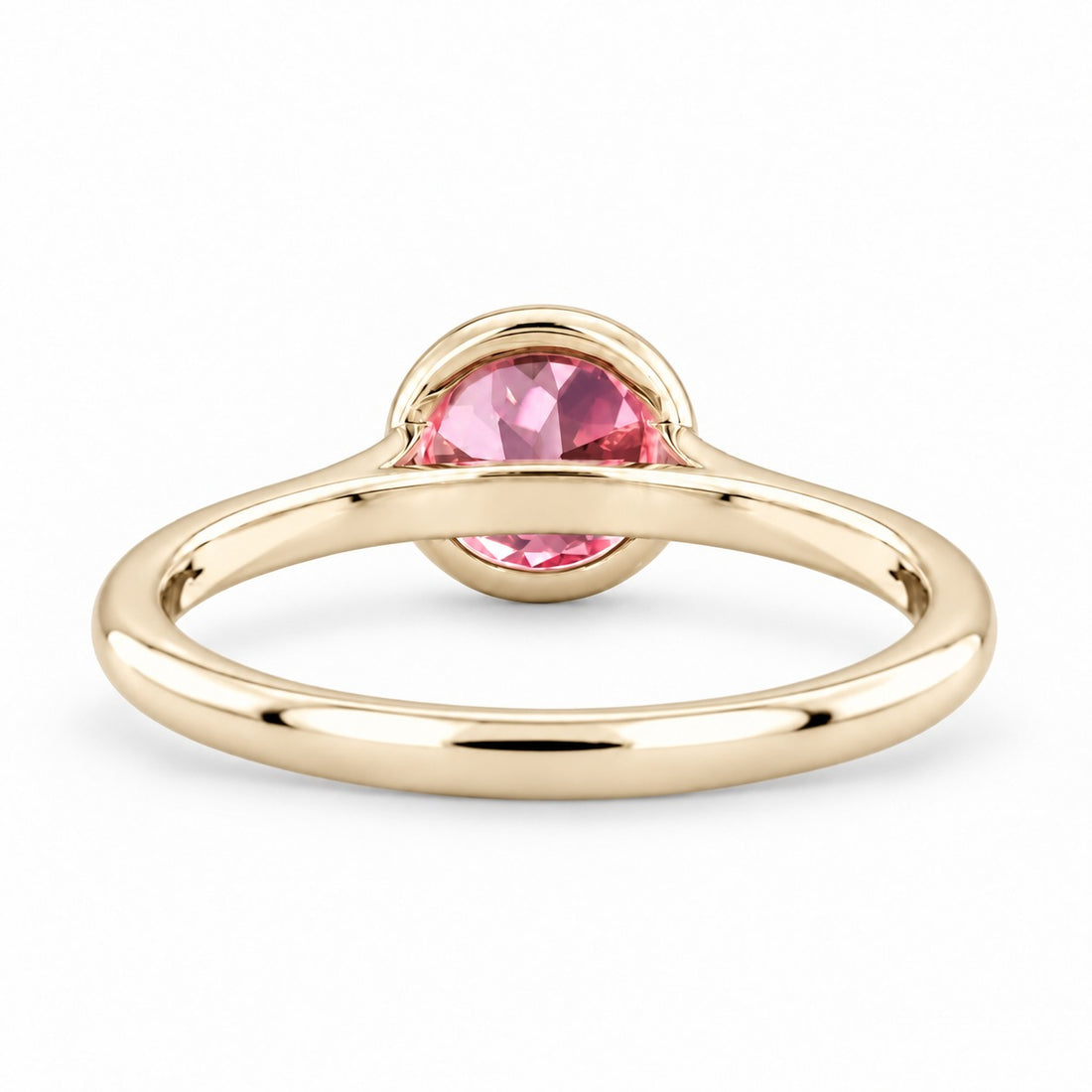 The Lune pink lab sapphire bezel solitaire ring in 14K yellow gold, back view