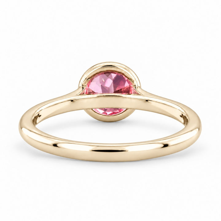 The Lune pink lab sapphire bezel solitaire ring in 14K yellow gold, back view