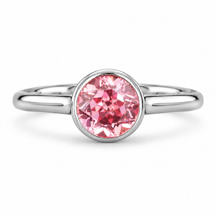 The Lune — Pink Round Sapphire Bezel Solitaire Ring in platinum, front view