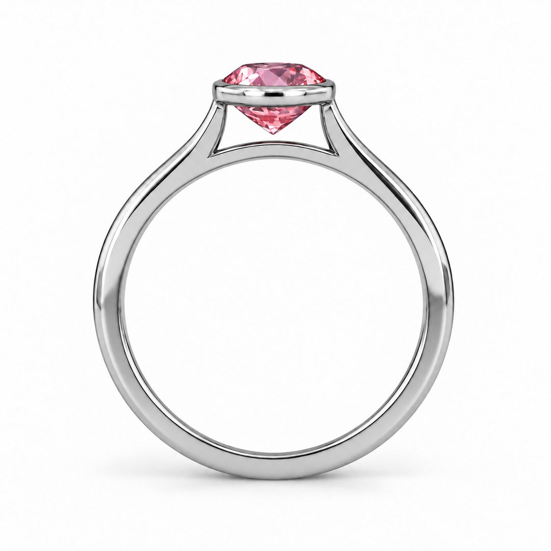 The Lune pink lab sapphire bezel solitaire ring in platinum, profile view
