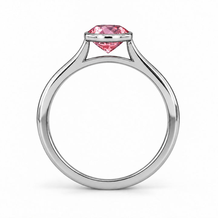 The Lune pink lab sapphire bezel solitaire ring in platinum, profile view