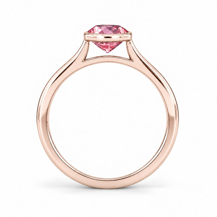 The Lune pink lab sapphire bezel solitaire ring in 14K rose gold, profile view