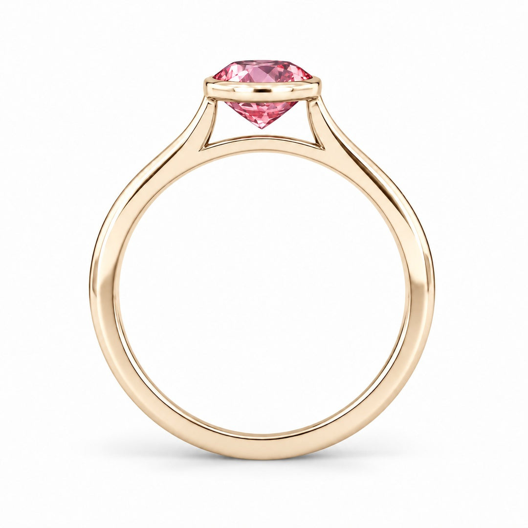 The Lune pink lab sapphire bezel solitaire ring in 14K yellow gold, profile view