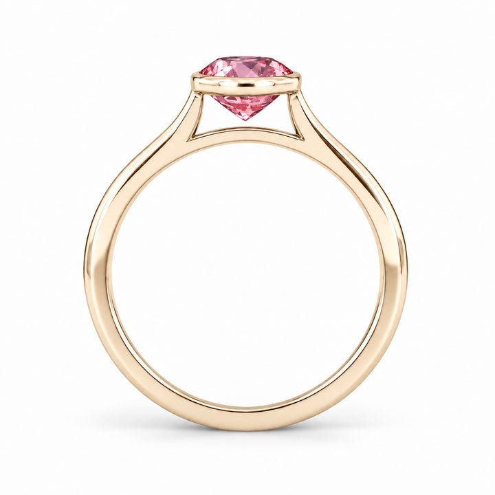 The Lune pink lab sapphire bezel solitaire ring in 14K yellow gold, profile view