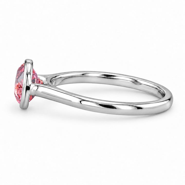 The Lune pink lab sapphire bezel solitaire ring in platinum, side view