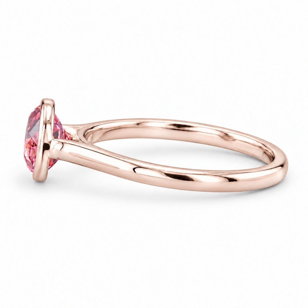 The Lune pink lab sapphire bezel solitaire ring in 14K rose gold, side view