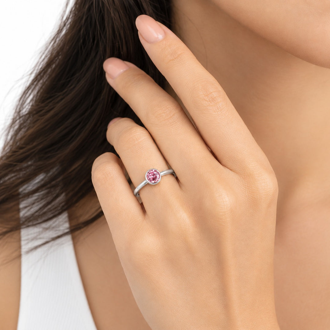 The Lune pink lab sapphire bezel solitaire ring in 14K white gold, worn on hand