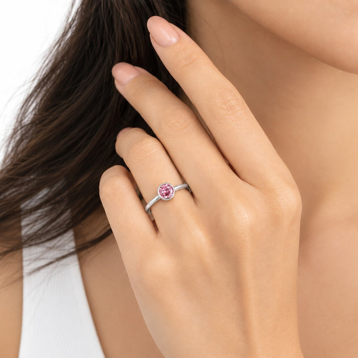 The Lune pink lab sapphire bezel solitaire ring in 14K white gold, worn on hand
