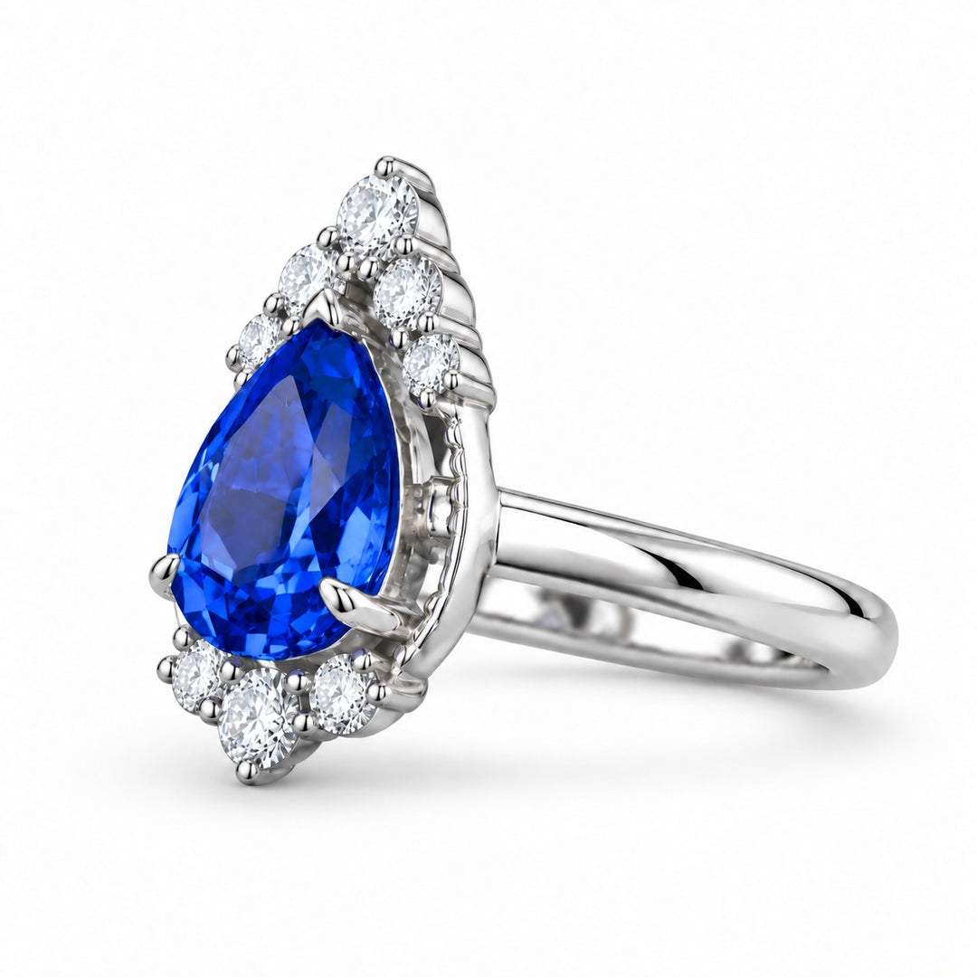 The Teardrop pear blue sapphire ring with diamond halo in platinum, angled view