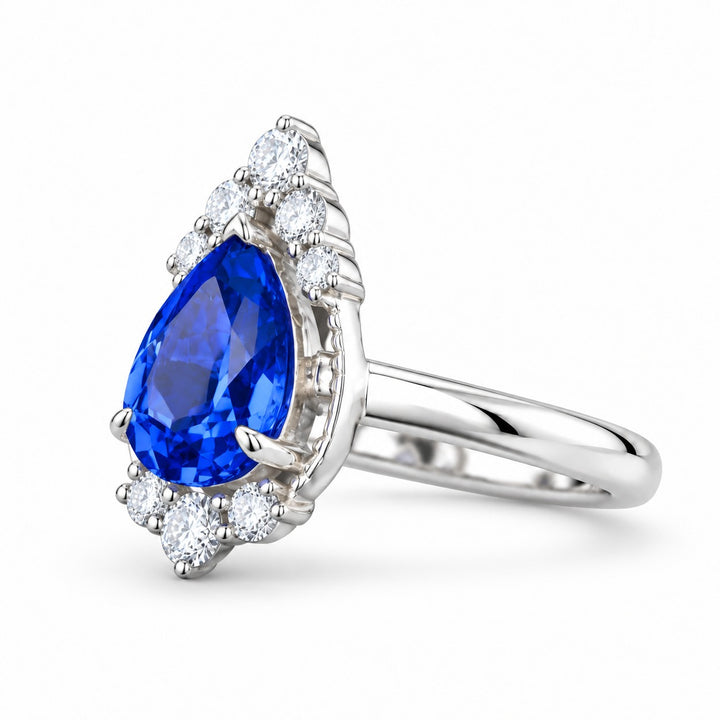 The Teardrop pear blue sapphire ring with diamond halo in 14K white gold, angled view