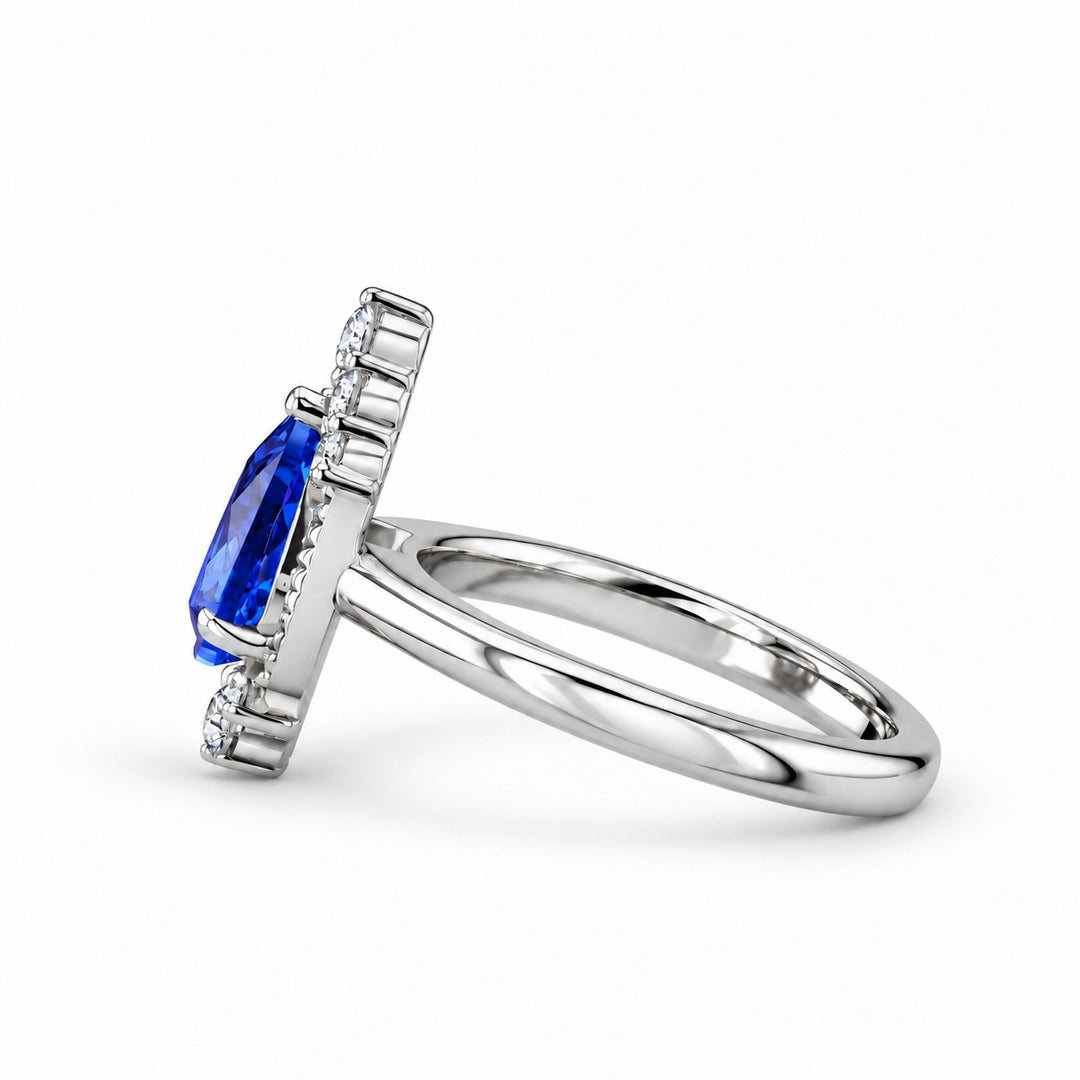 The Teardrop pear blue sapphire ring with diamond halo in platinum, side view