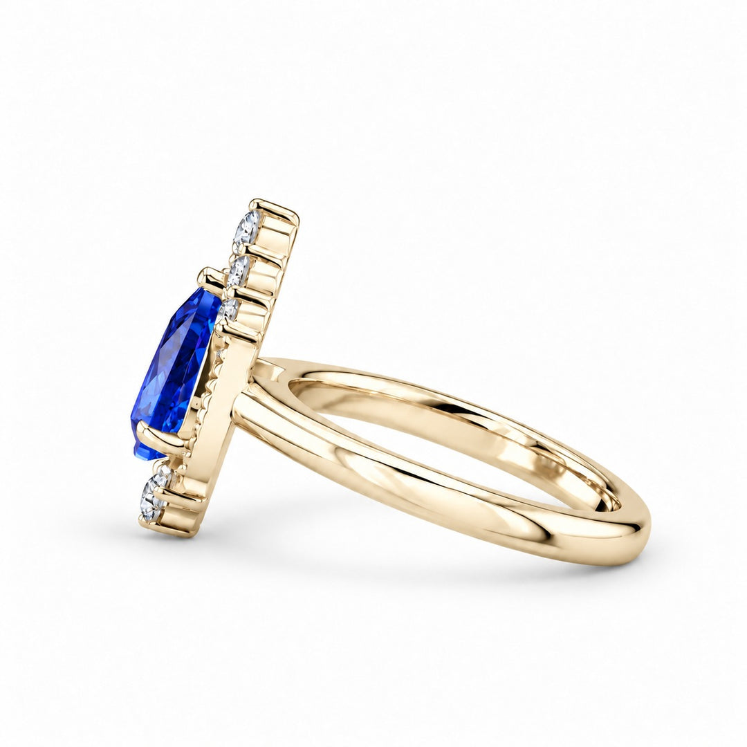 The Teardrop pear blue sapphire ring with diamond halo in 14K yellow gold, side view