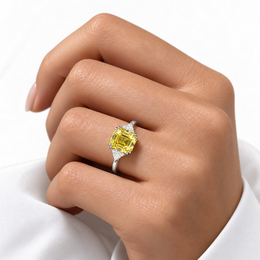 The Sundial asscher yellow lab sapphire three-stone ring in 14K white gold, worn on hand