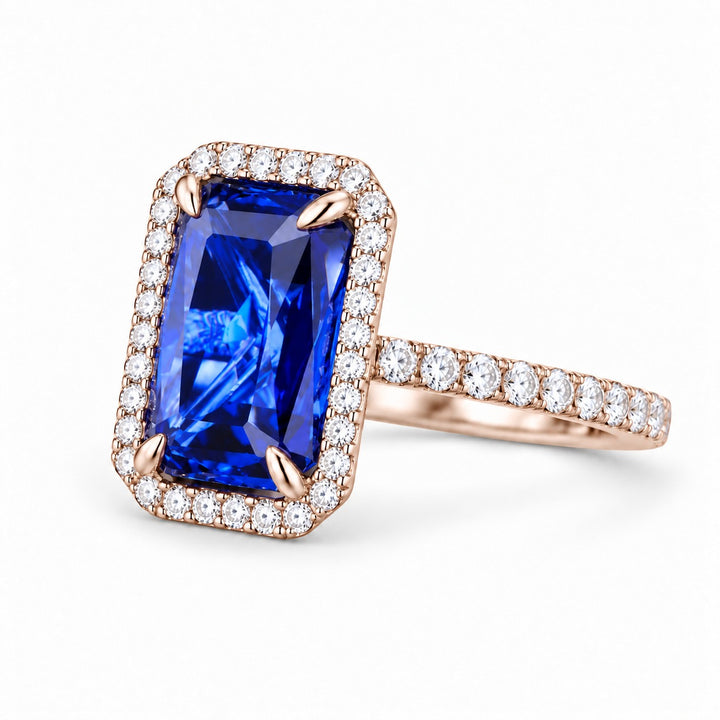 The Regalia emerald-cut lab sapphire halo ring in 14K rose gold, angled view