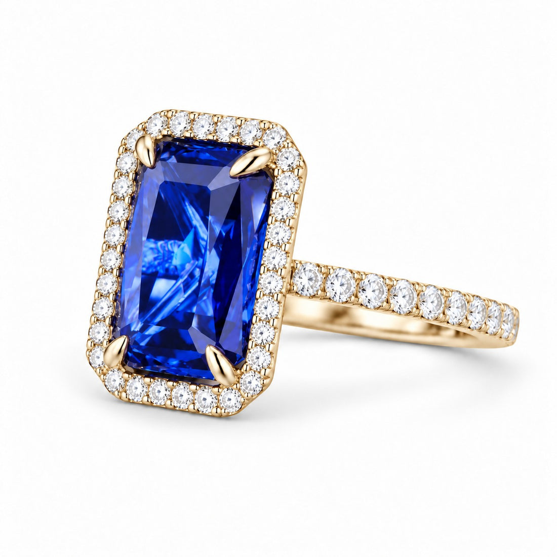 The Regalia emerald-cut lab sapphire halo ring in 14K yellow gold, angled view