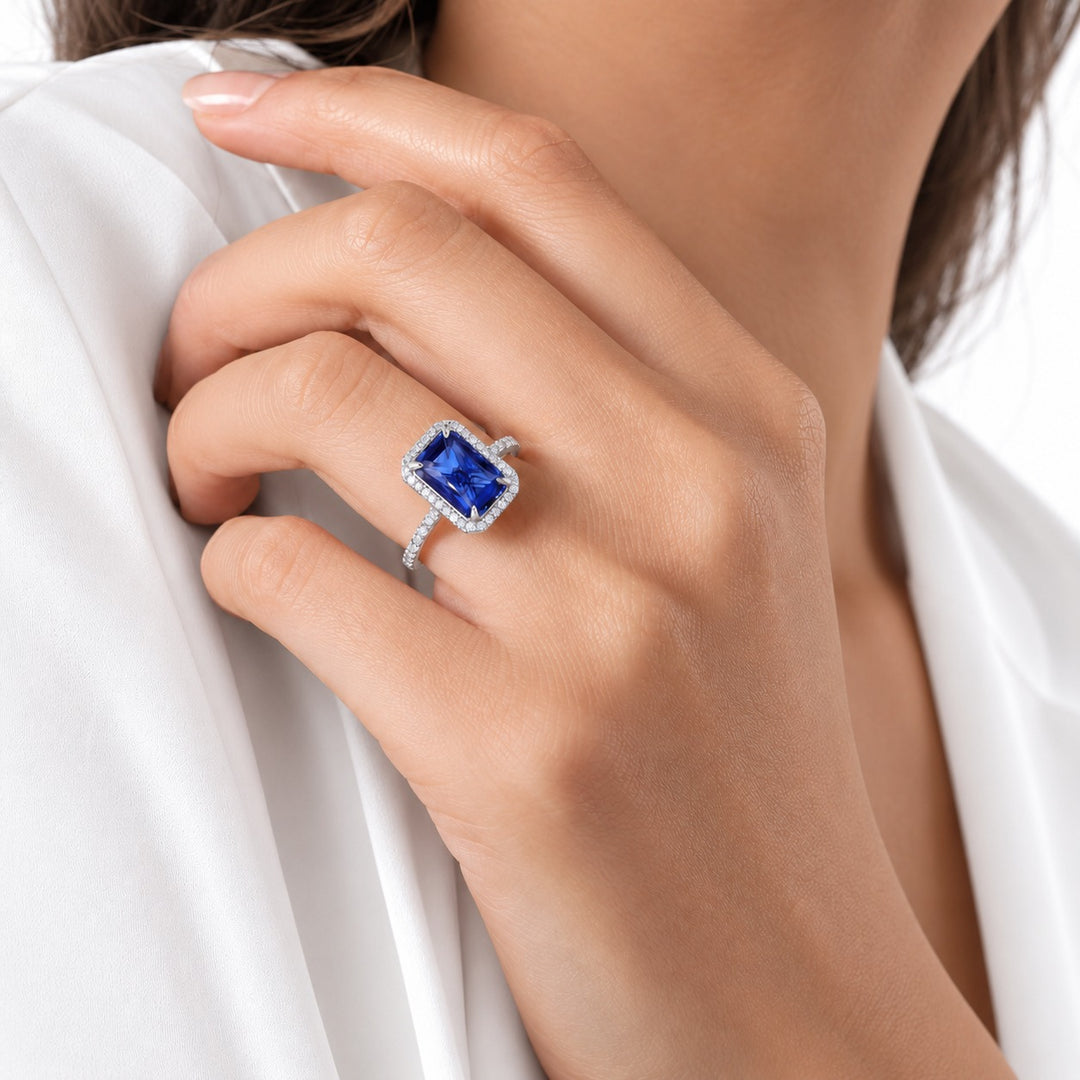 The Regalia emerald-cut lab sapphire halo ring in 14K white gold, worn on hand
