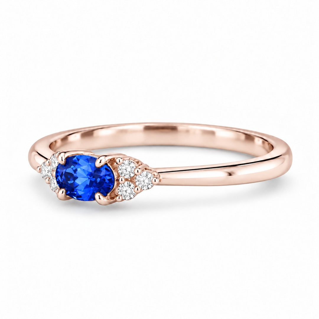 The Wren east-west oval blue sapphire ring in 14K rose gold, angled view