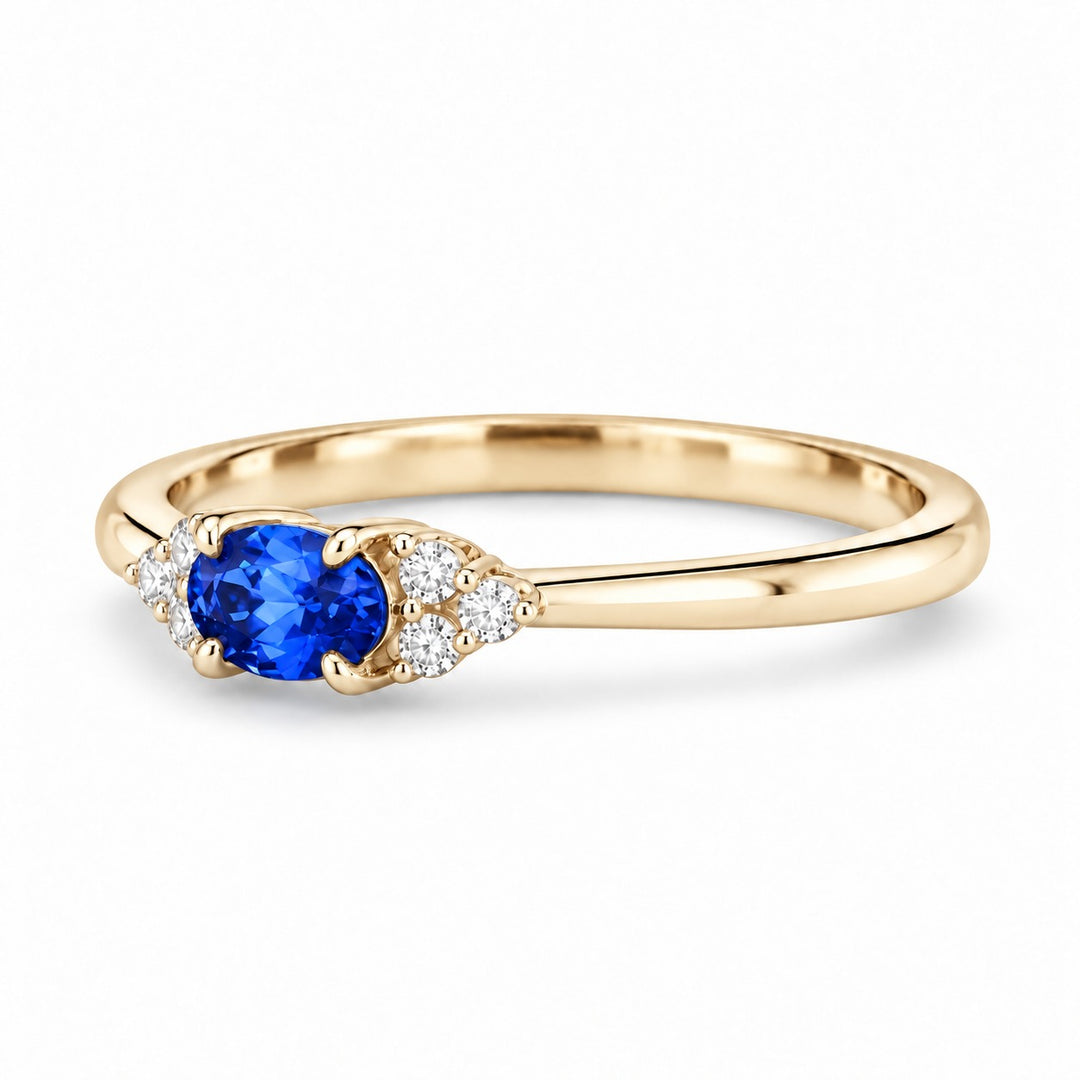 The Wren east-west oval blue sapphire ring in 14K yellow gold, angled view
