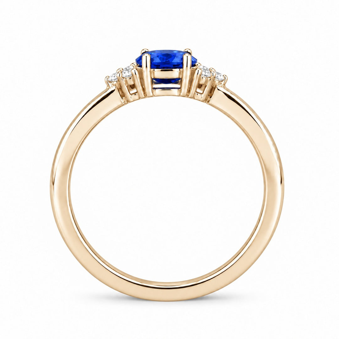 The Wren east-west oval blue sapphire ring in 14K yellow gold, profile view