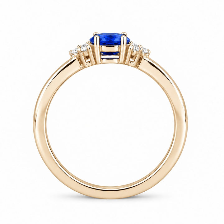 The Wren east-west oval blue sapphire ring in 14K yellow gold, profile view