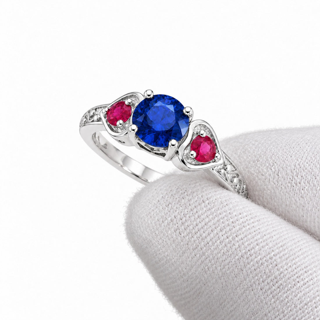 Sapphire and ruby three-stone ring with leaf band in sterling silver, angled view