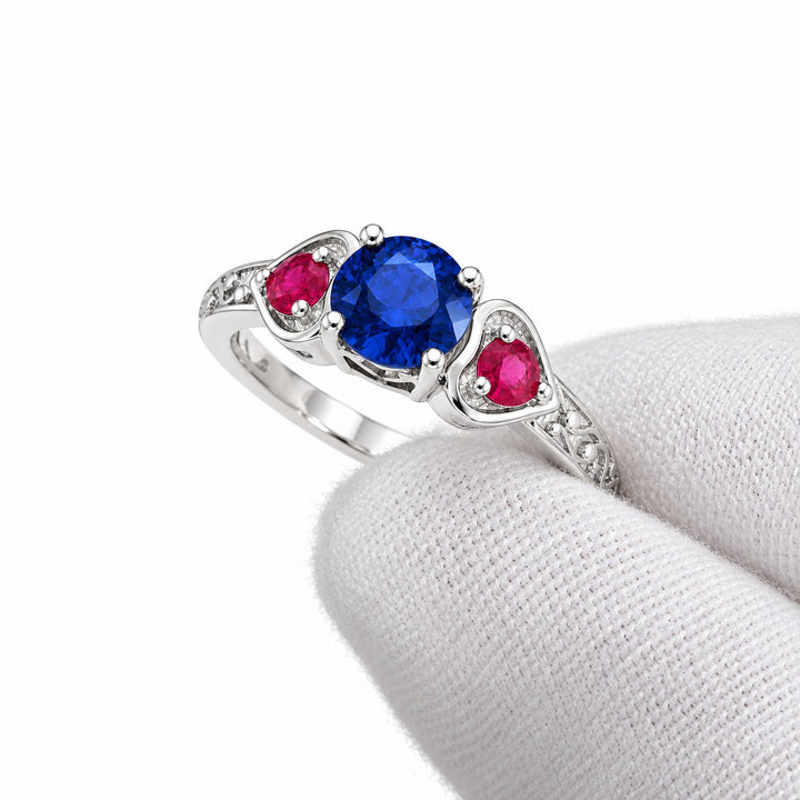 Sapphire and ruby three-stone ring with leaf band in 14K white gold, angled view