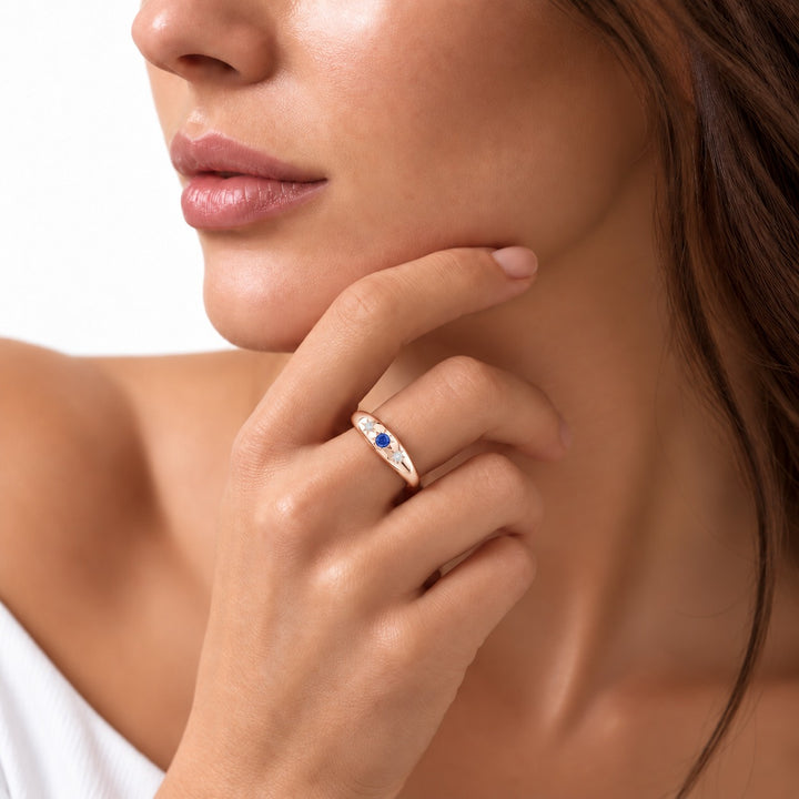 The Stella blue sapphire star-set dome band in 14K rose gold, worn on hand