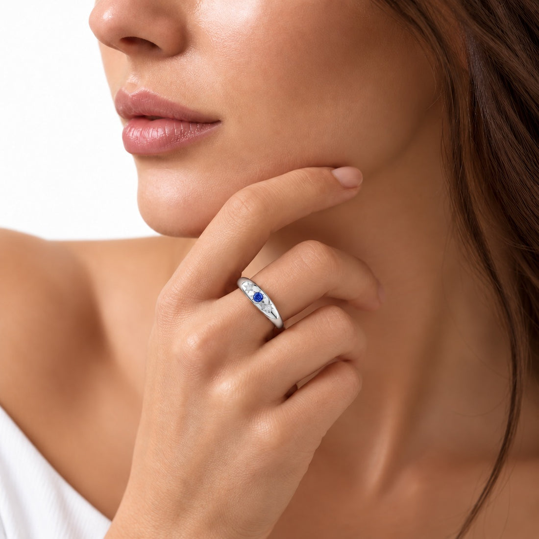 The Stella blue sapphire star-set dome band in 14K white gold, worn on hand