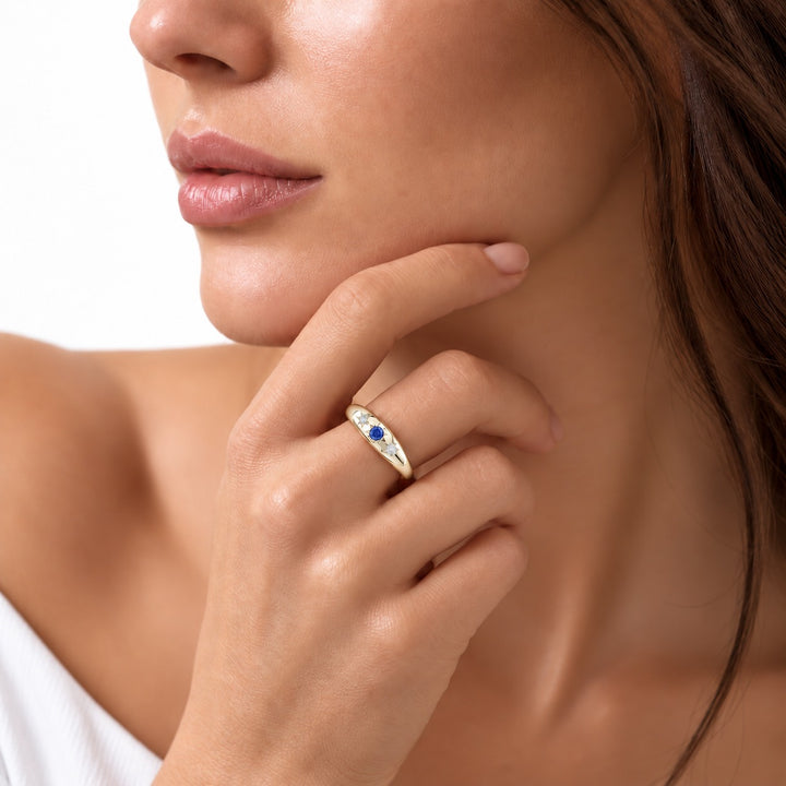 The Stella blue sapphire star-set dome band in 14K yellow gold, worn on hand